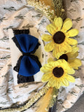 Dark blue bow with black lace accent