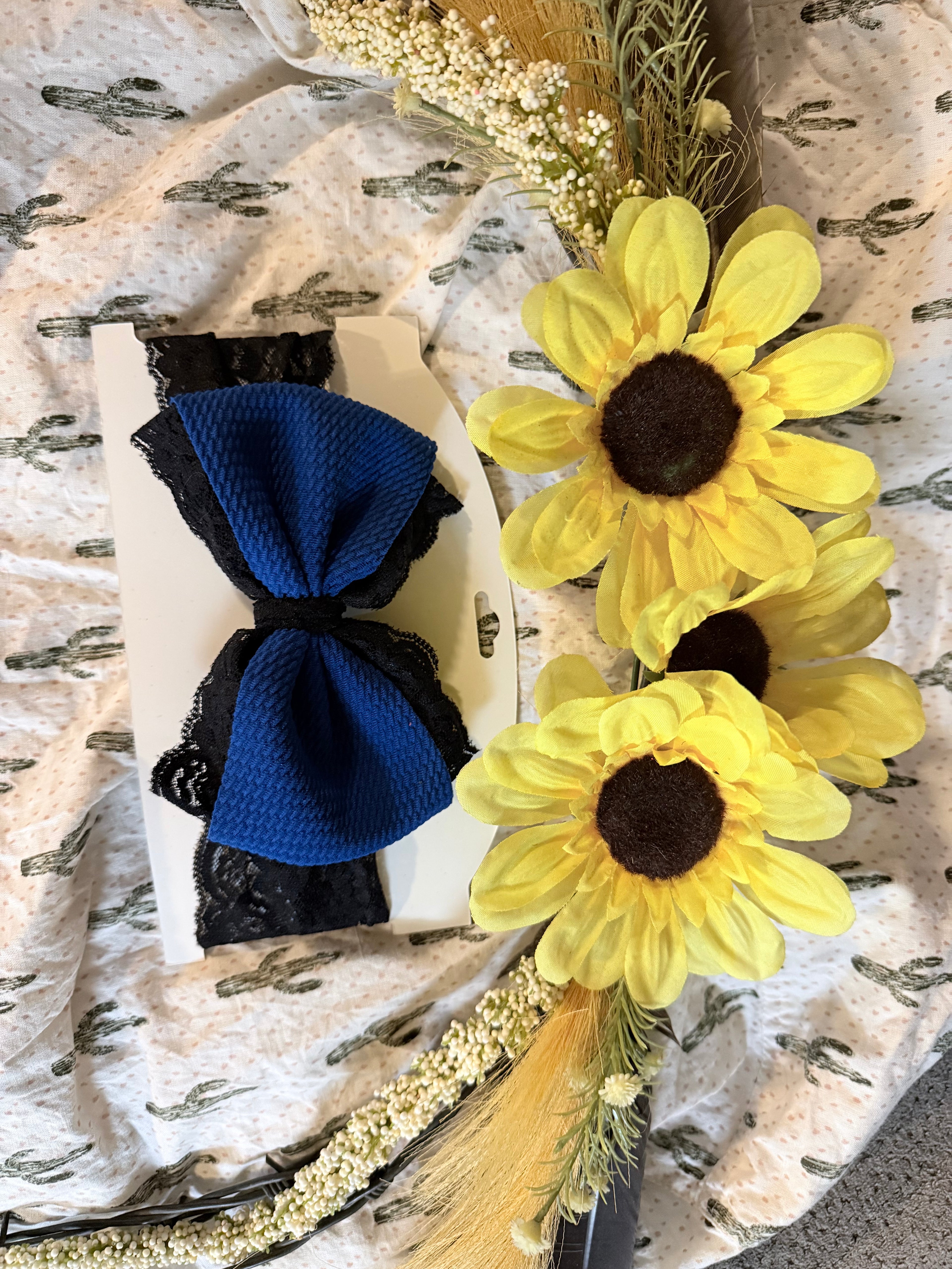 Dark blue bow with black lace accent